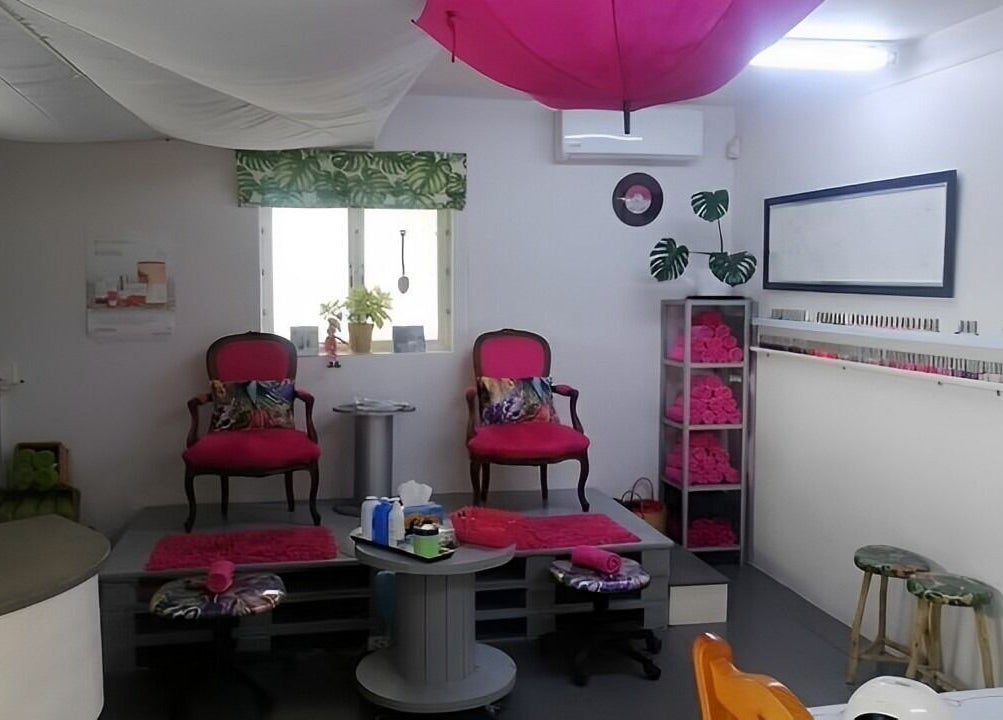 Cozy interior of Pop in Beauty Bar, Saint Francis Bay, ZA, with plush chairs and stylish decor.