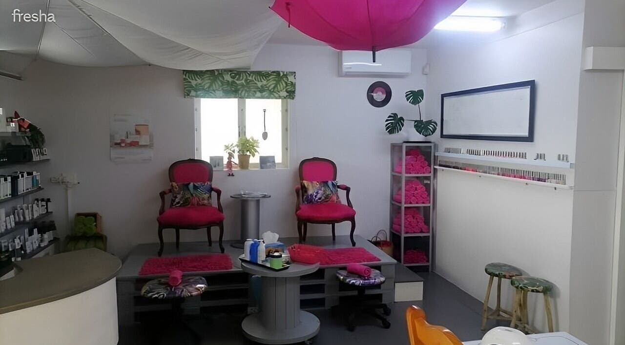 Cozy interior of Pop in Beauty Bar, Saint Francis Bay, ZA, with plush chairs and stylish decor.