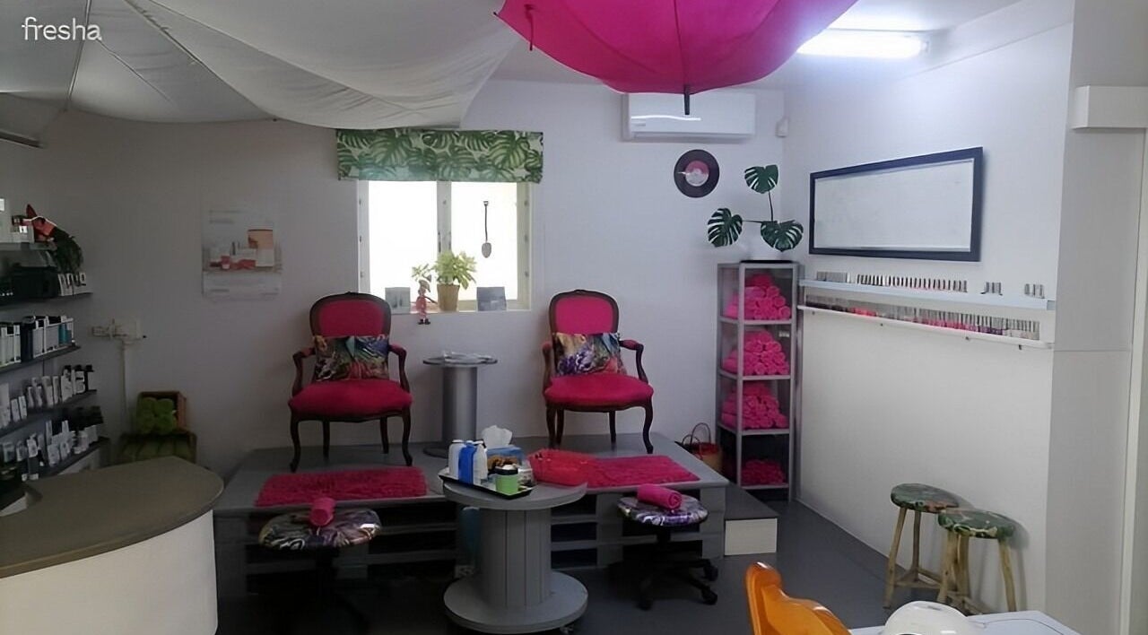 Cozy interior of Pop in Beauty Bar, Saint Francis Bay, ZA, with plush chairs and stylish decor.