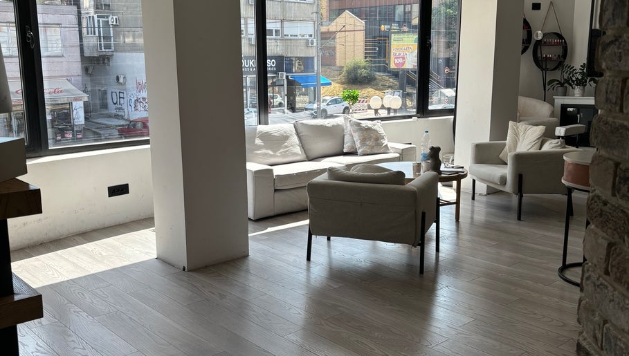 Spacious and cozy lounge at In epill centar, Beograd, RS, with plush seating and large windows.