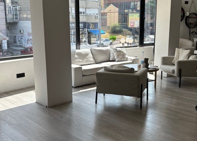 Spacious and cozy lounge at In epill centar, Beograd, RS, with plush seating and large windows.