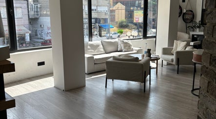 Spacious and cozy lounge at In epill centar, Beograd, RS, with plush seating and large windows.