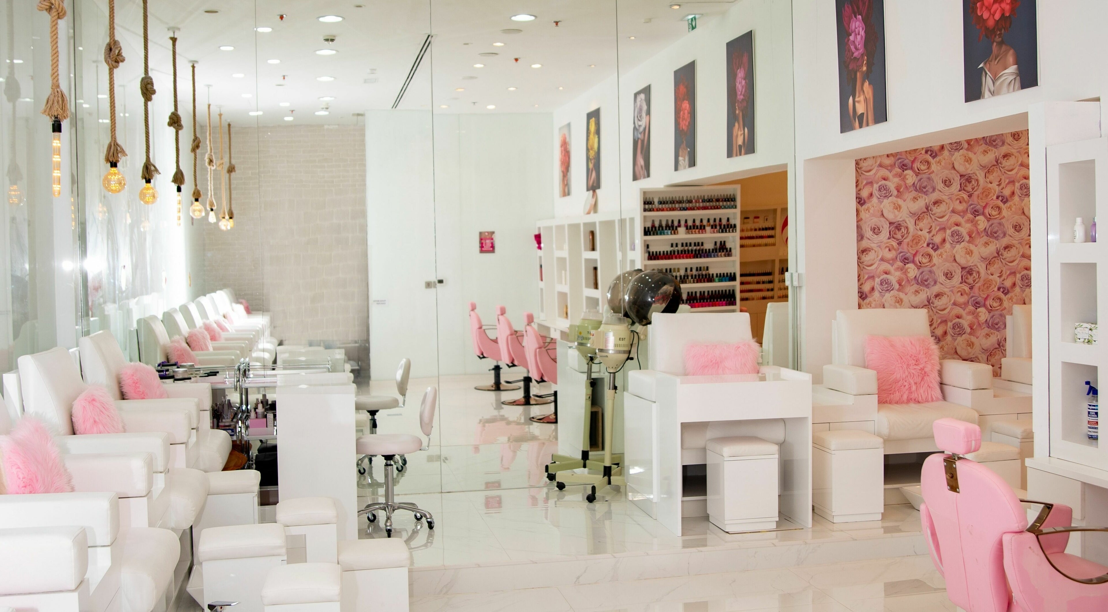 Stylish interior of Mrs Cutting Edge Ladies Salon - Ibn Battuta Mall, Dubai, AE with chic white decor and pink accents.