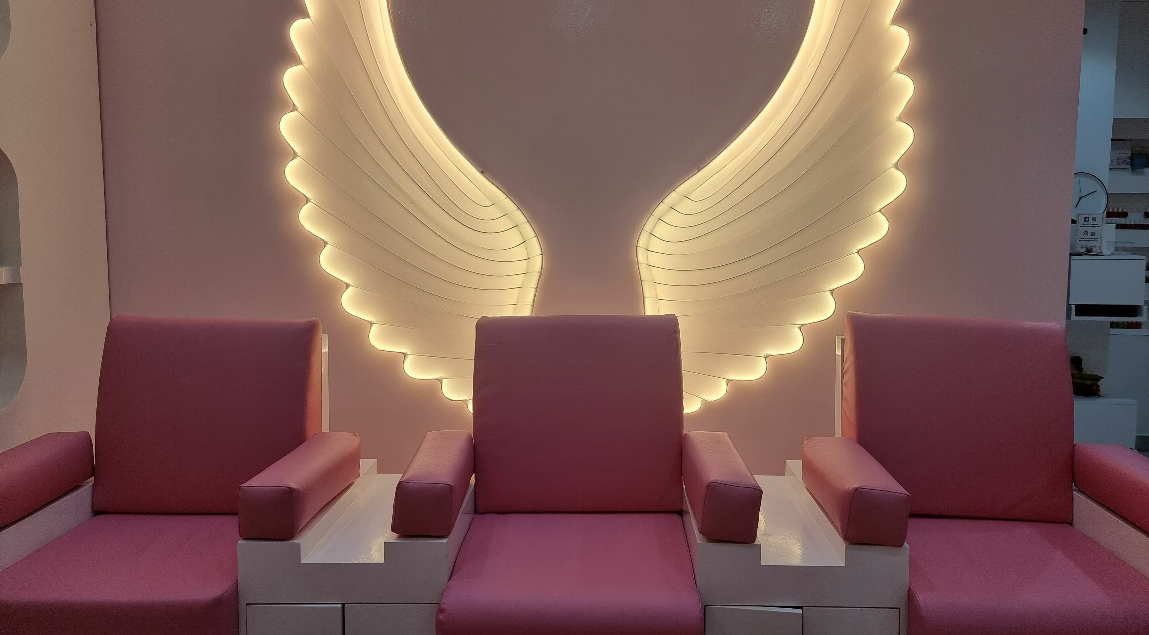 Elegant seating with angel wing lights at Cutting Edge Hair Lounge Dmcc - Cluster U JLT, Dubai, Dubai, AE.