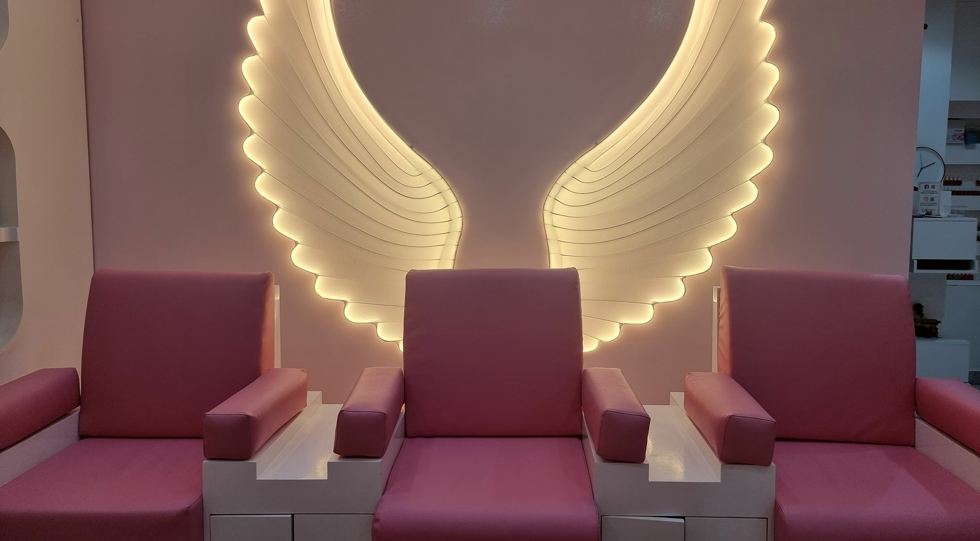 Elegant seating with angel wing lights at Cutting Edge Hair Lounge Dmcc - Cluster U JLT, Dubai, Dubai, AE.