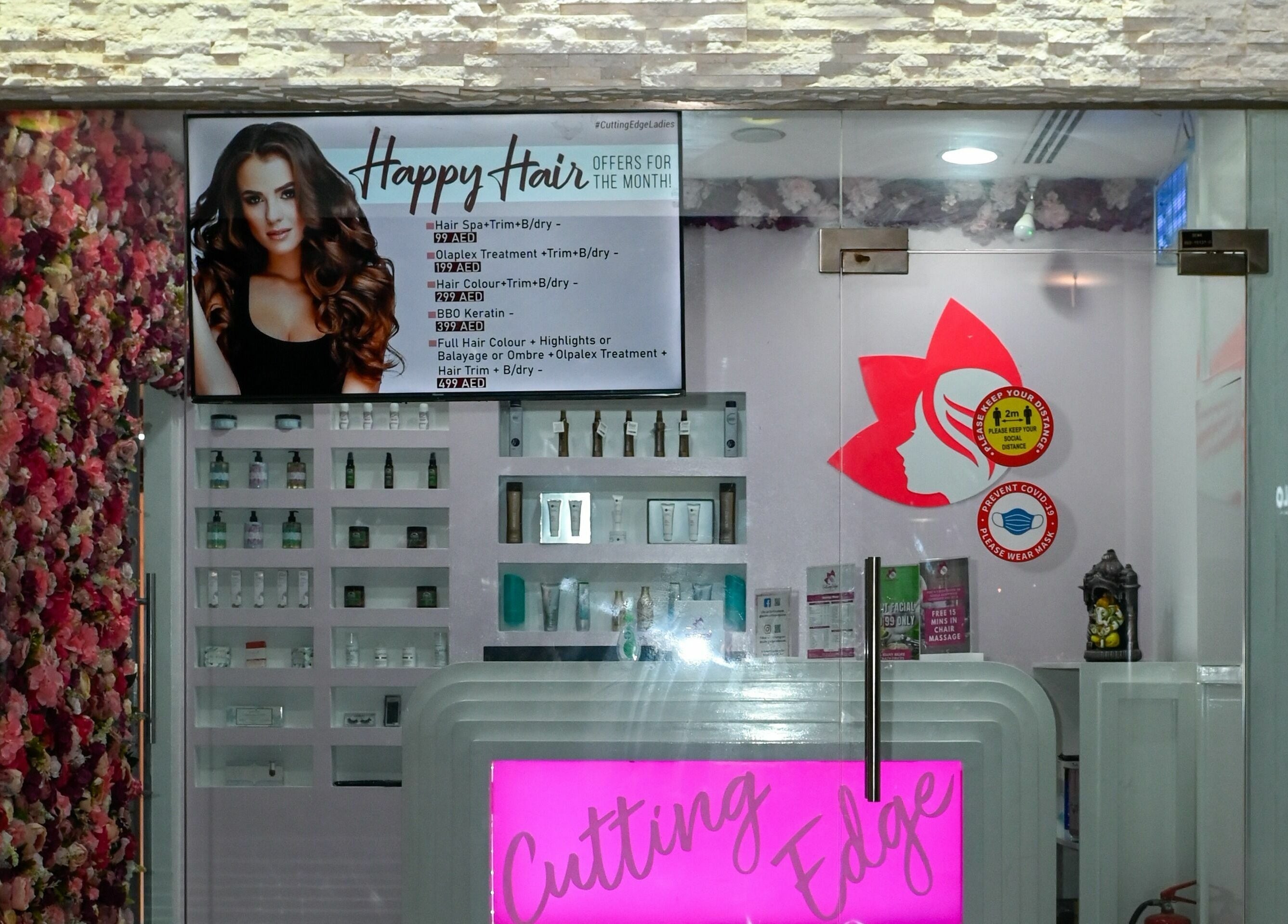 Entrance of Cutting Edge Hair Lounge Dmcc - Cluster U JLT, vibrant flowers and sign, Dubai, Dubai, AE.