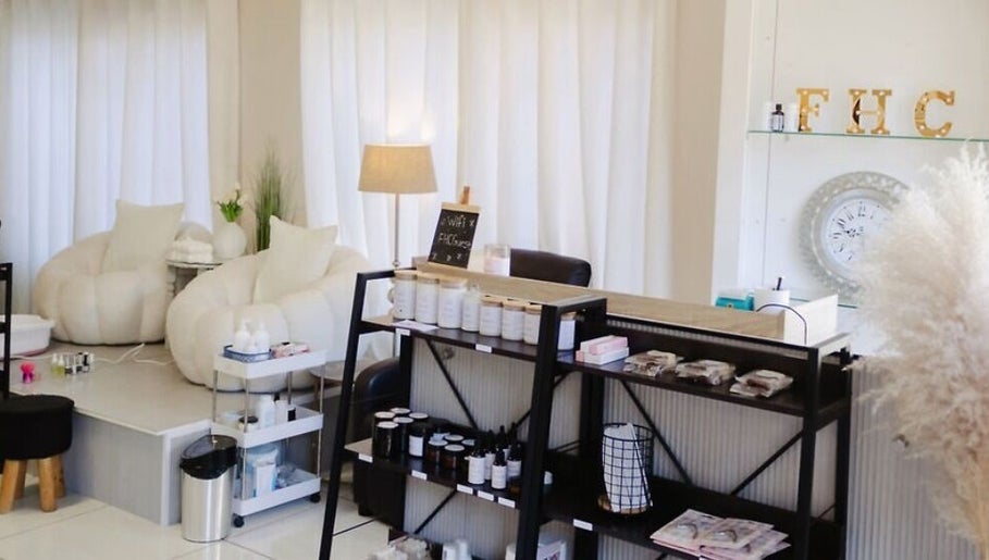 Spacious, serene interior of Fix Her Crown, Benoni, Gauteng, ZA, showcasing plush seating and beauty products.