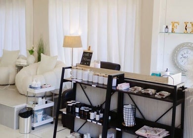 Chic lounge at Fix Her Crown, Benoni, Gauteng, ZA with cozy chairs and a stylish display shelf.