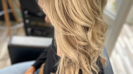 Blonde hair styled in elegant waves at Liam Dawson Hair in Ashford, England, GB.