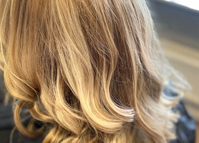 Blonde hair styling at Liam Dawson Hair in Ashford, England, GB. Perfectly curled and polished look.