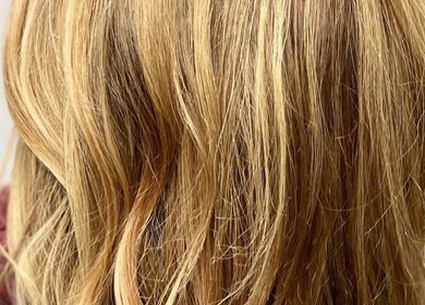 Blonde hair styling at Liam Dawson Hair, Betherson, England, GB. Luxurious waves in a warm, golden hue.