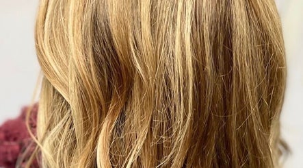 Blonde hair styling at Liam Dawson Hair, Betherson, England, GB. Luxurious waves in a warm, golden hue.