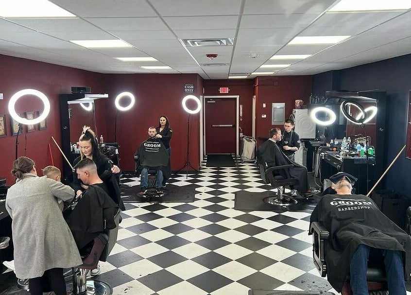 Interior of Groom Barbershop in Easthampton, Massachusetts, US showcasing haircuts in progress.