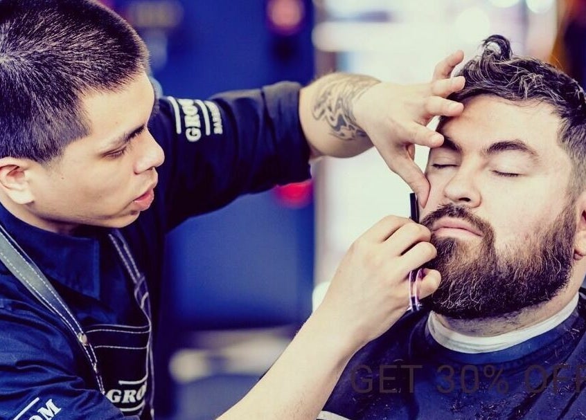 Professional grooming at Groom Barbershop in Easthampton, Massachusetts, US. Barber shaping beard with precision.