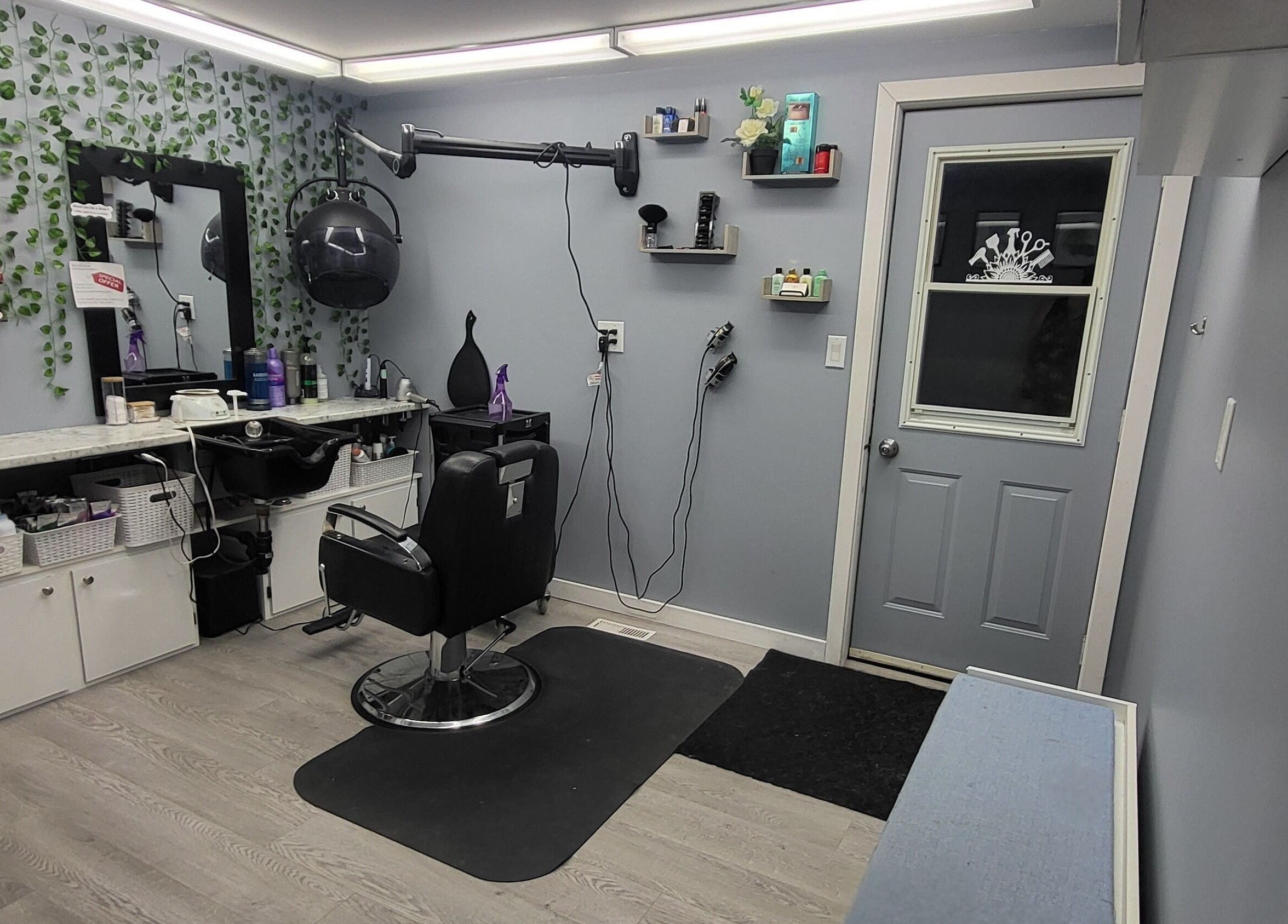 Modern interior of Tiffany's Home Salon in Ste-Geneviève, Manitoba, CA with stylish decor and hair styling station.