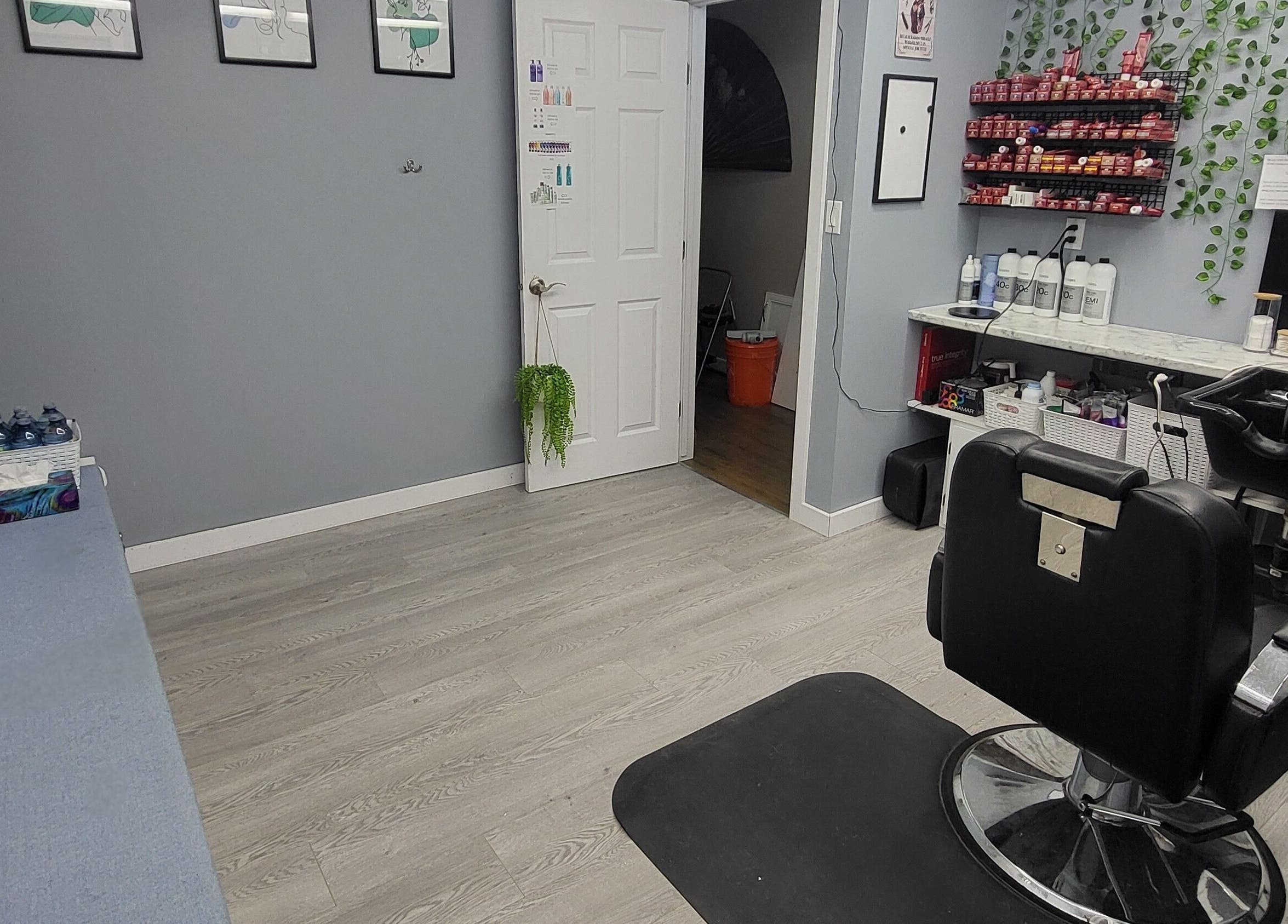 Interior of Tiffany's Home Salon in Ste-Geneviève, Manitoba, CA showcasing modern styling chair and colorful products.