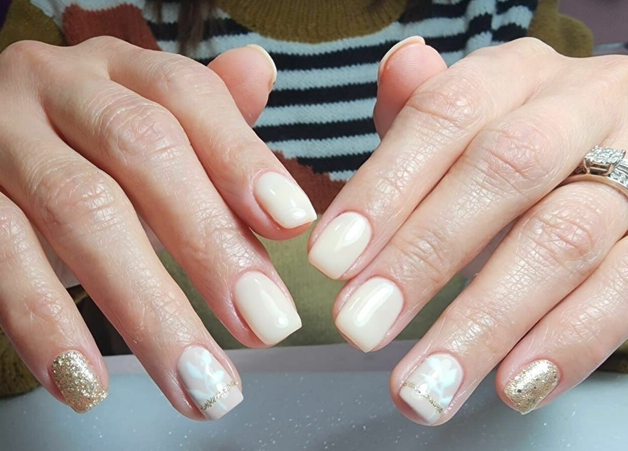 Stylish manicure at Cleopatra Beauty Salon & Spa, Dubai, Dubai, AE featuring glossy and glitter nails.