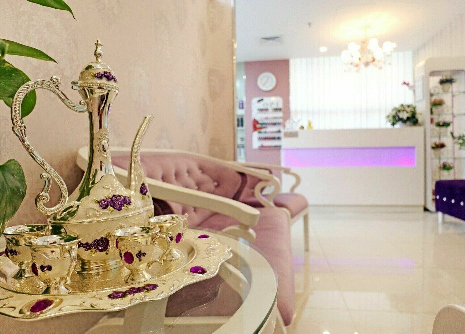 Luxurious lounge at Cleopatra Beauty Salon & Spa, Dubai, AE, with ornate tea set and elegant decor.