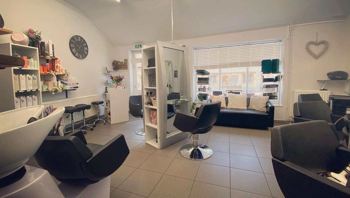 House of Hair salon interior in Somerton, England, GB showcasing modern chairs and products.