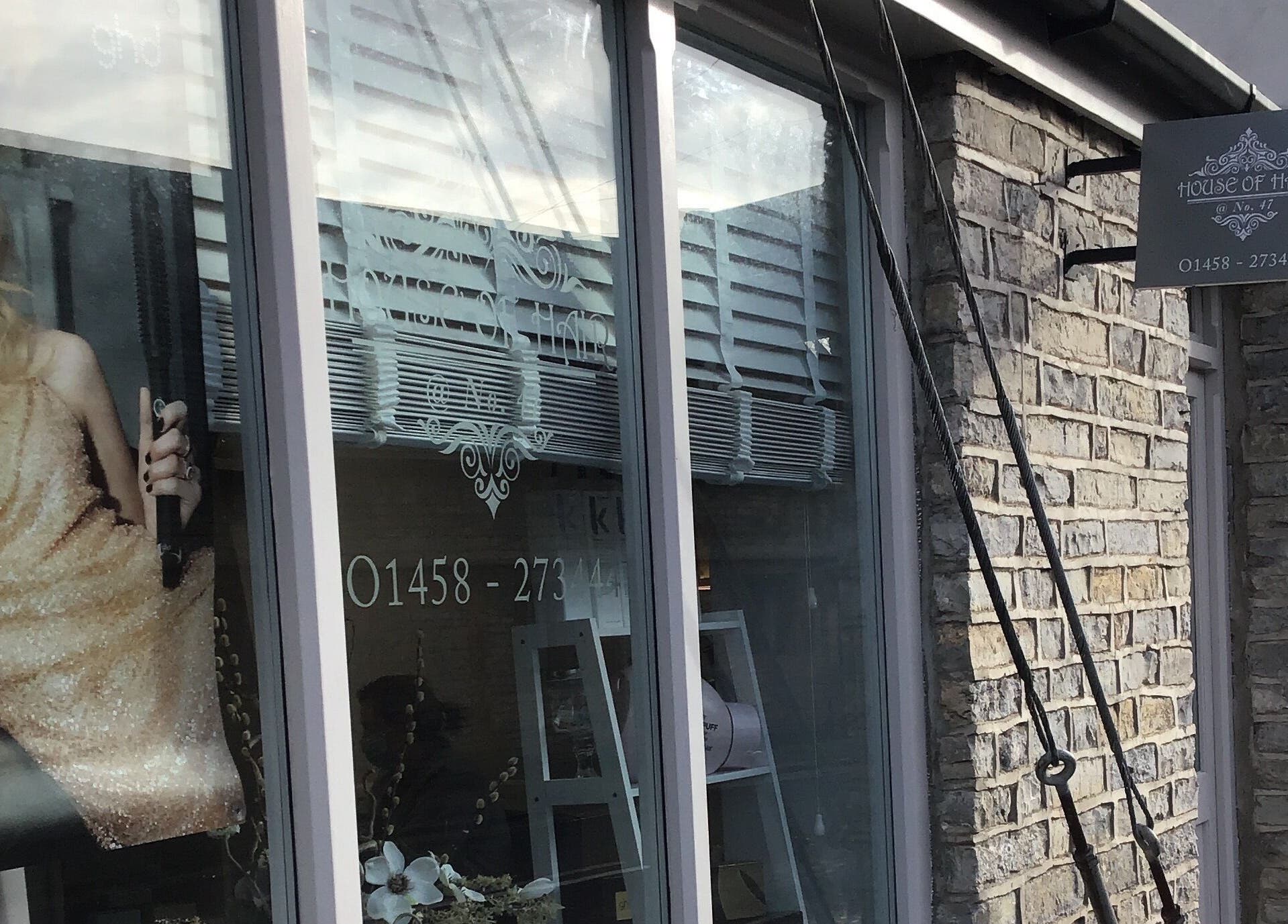 Front view of House of Hair in Somerton, England, featuring elegant signage and stylish window display.