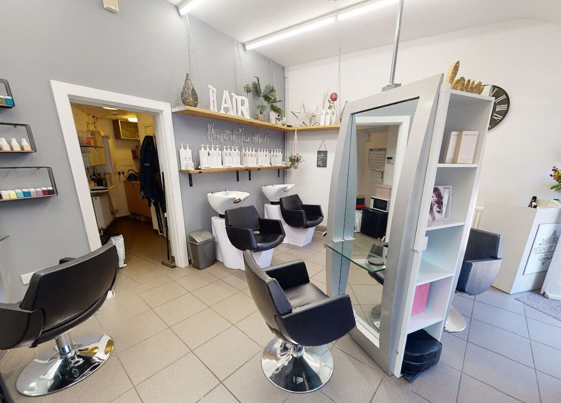 Interior of House of Hair salon in Somerton, England, featuring modern chairs and hair washing stations.