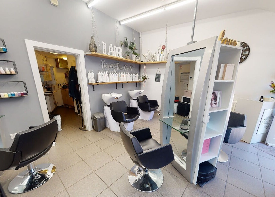 Interior of House of Hair salon in Somerton, England, featuring modern chairs and hair washing stations.