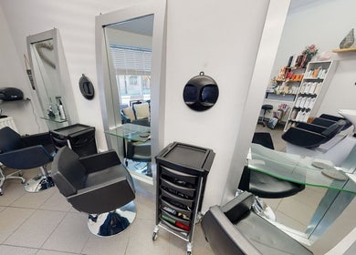 Chic interior of House of Hair, Somerton, England, GB, showcasing modern styling chairs and mirrors.
