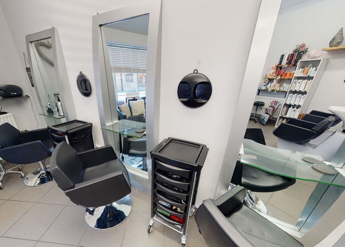Chic interior of House of Hair, Somerton, England, GB, showcasing modern styling chairs and mirrors.