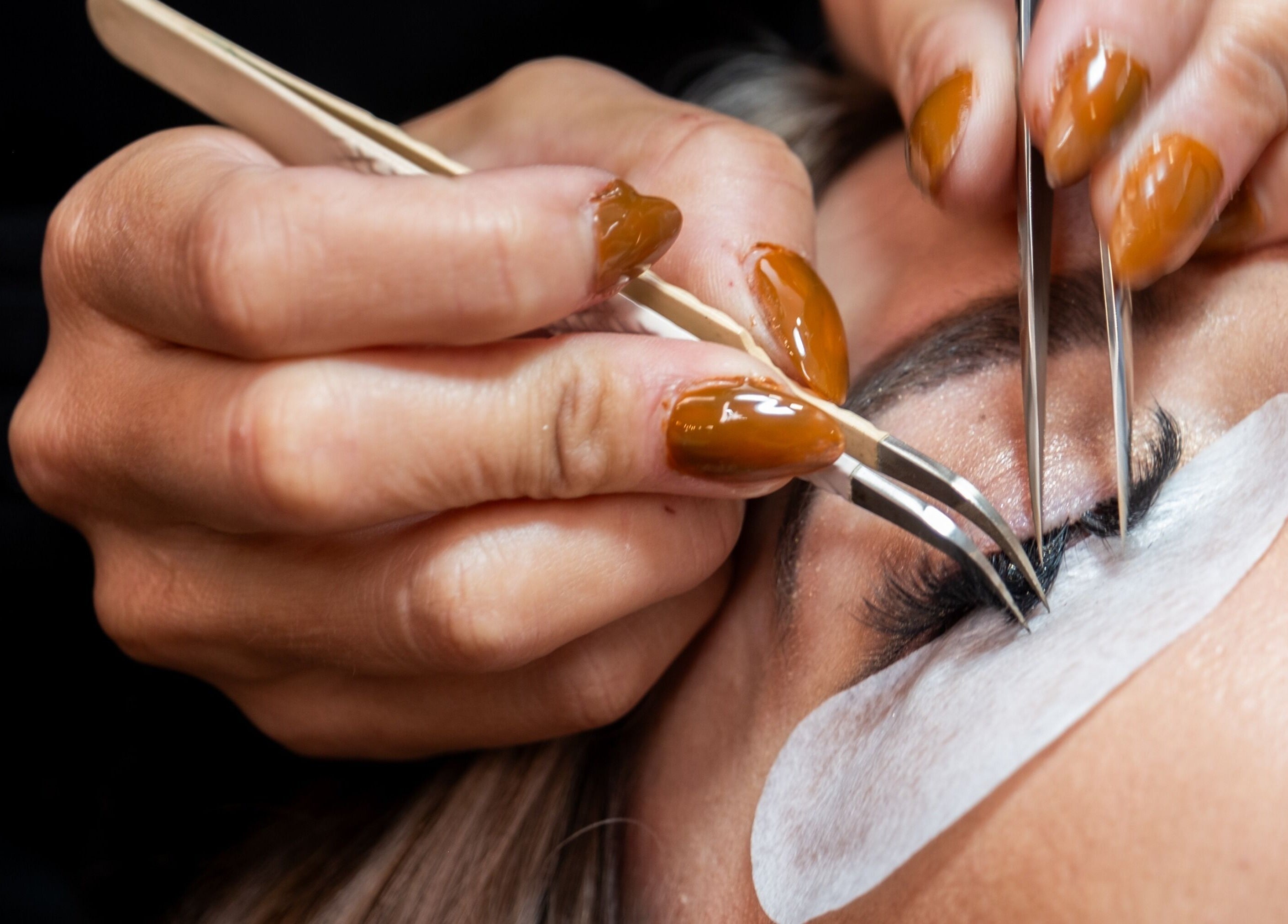 Close-up of lash extension application at Bright Esthetics, Yucaipa, California, US. Skilled artistry and care.