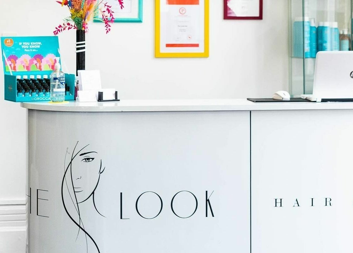 Reception desk at The Look, Abingdon, England, GB with bright decor and branded design.