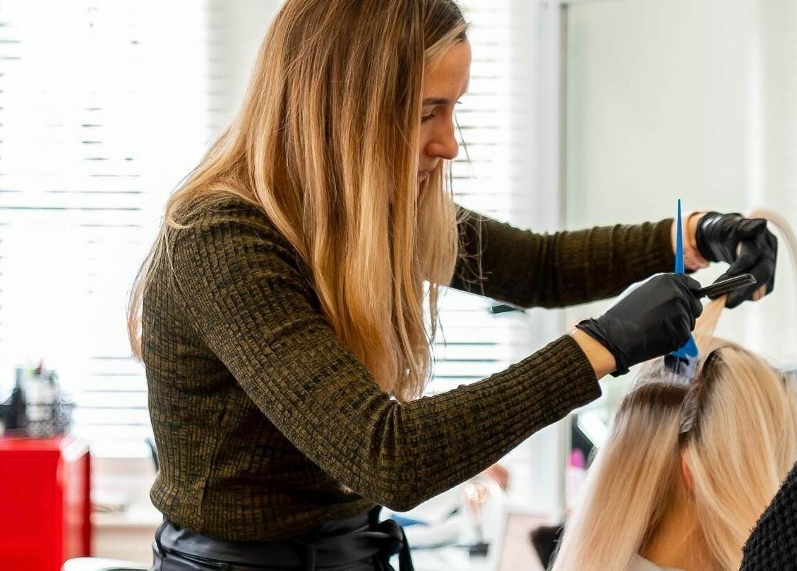 Hairstylist creating a chic look at The Look, Abingdon, England, GB. Highlighting expert care.