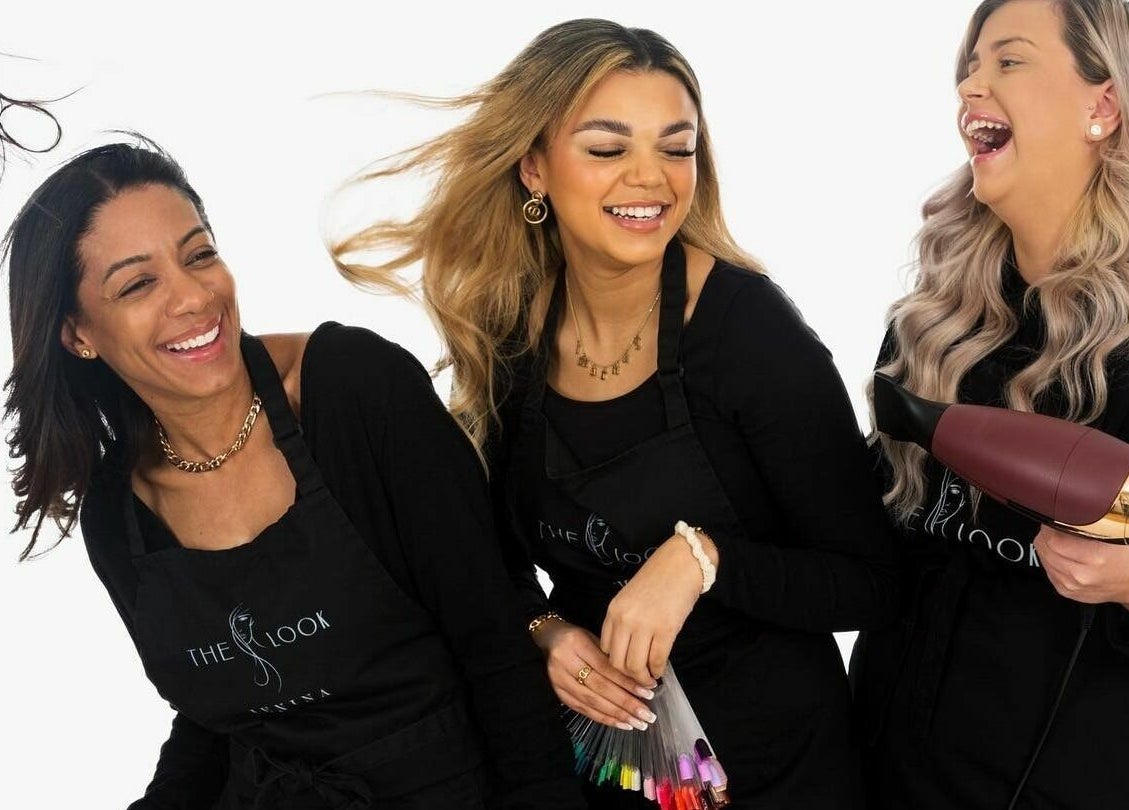 Happy stylists at The Look, Abingdon, England, GB share a laugh, embodying beauty and professionalism.