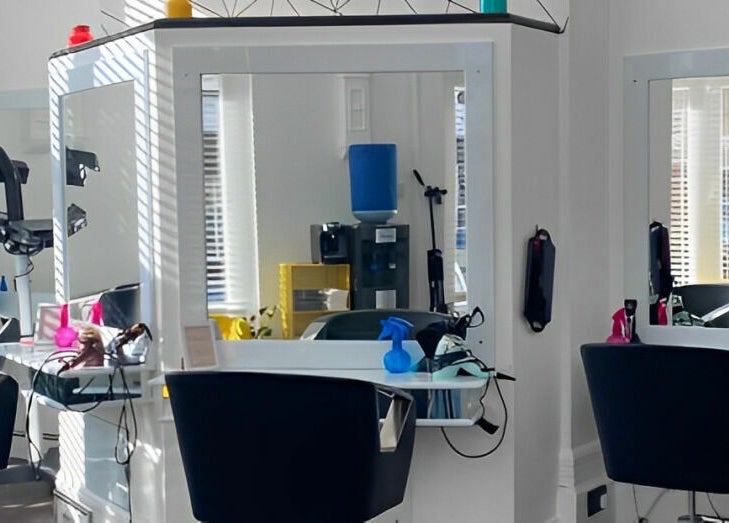 Modern salon station at The Look Wheatley Edition in Wheatley, England, GB with sleek chairs and styling tools.