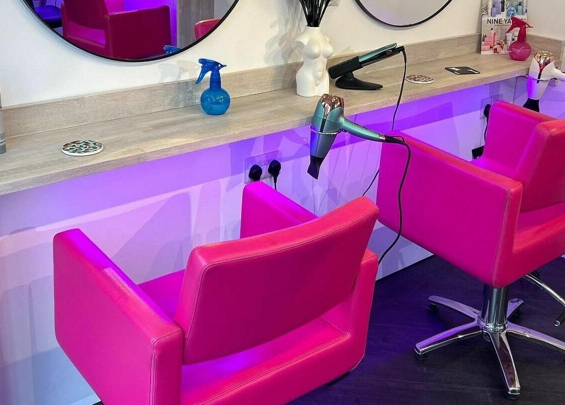 Modern salon interior with pink chairs at The Look Wheatley Edition, Wheatley, England, GB.