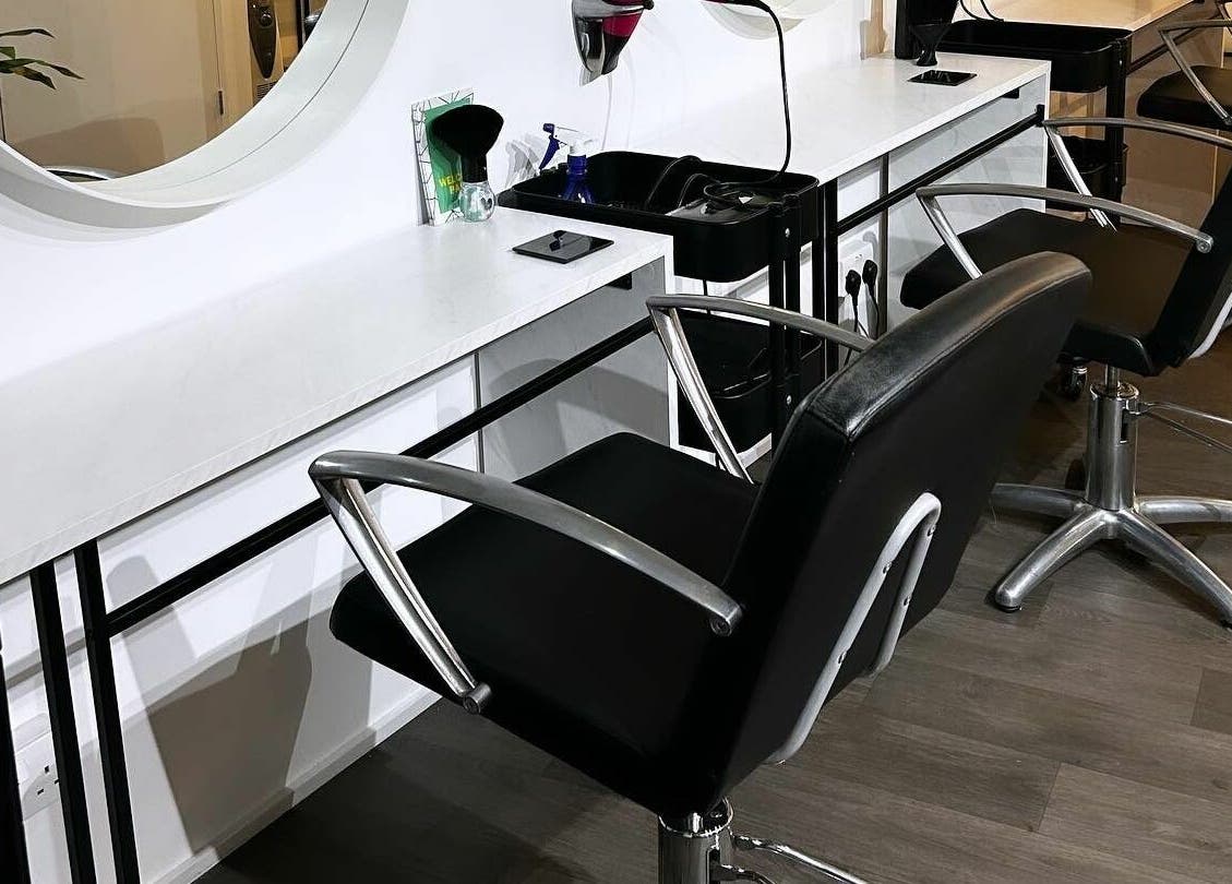 Modern salon interior at The Look Wheatley Edition, Wheatley, England, GB with sleek black styling chairs.
