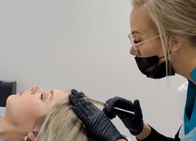 Professional administering hair treatment at 360 Hair Clinic, Brighton And Hove, England, GB.