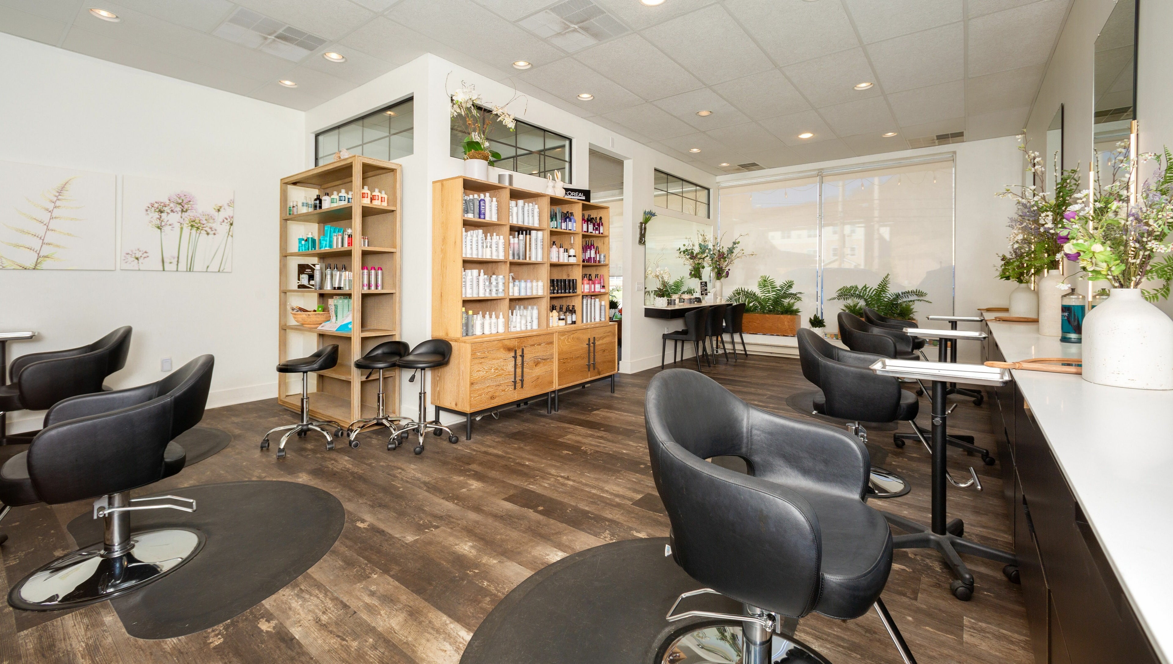 Elegant interior of Salon Bloom Color and Co. in Glenshaw, Pennsylvania, US, showcasing modern styling chairs.