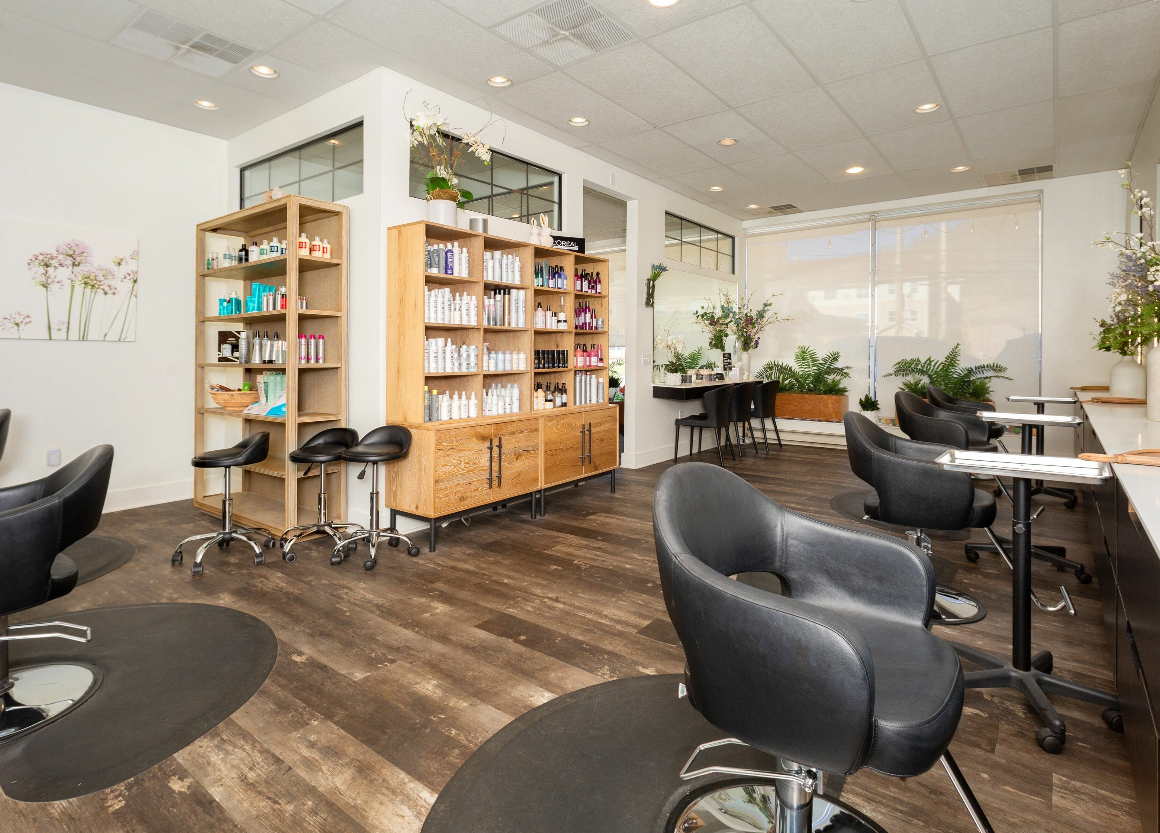 Elegant interior of Salon Bloom Color and Co. in Glenshaw, Pennsylvania, US, showcasing modern styling chairs.