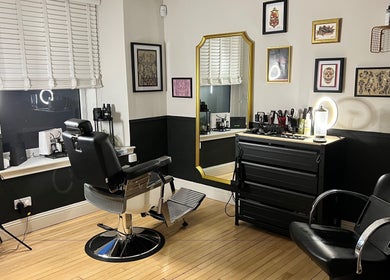 Stylish salon interior at New Street Collective in Bridge Of Allan, Scotland, GB, featuring a barber chair and decor.