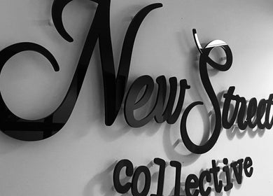 Elegant signage of New Street Collective at Bridge Of Allan, Scotland, GB, in stylish black lettering.