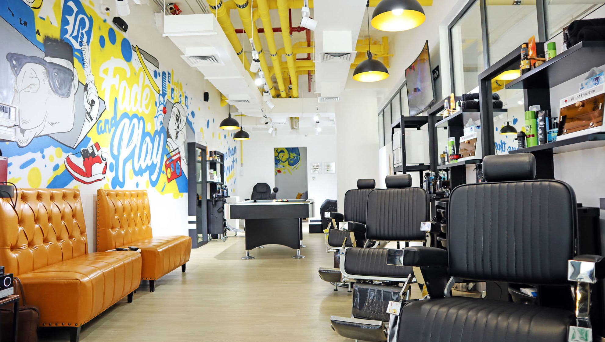 Modern interior of Fade & Play - Al Barsha in Dubai features artistry and stylish seating in a welcoming atmosphere.