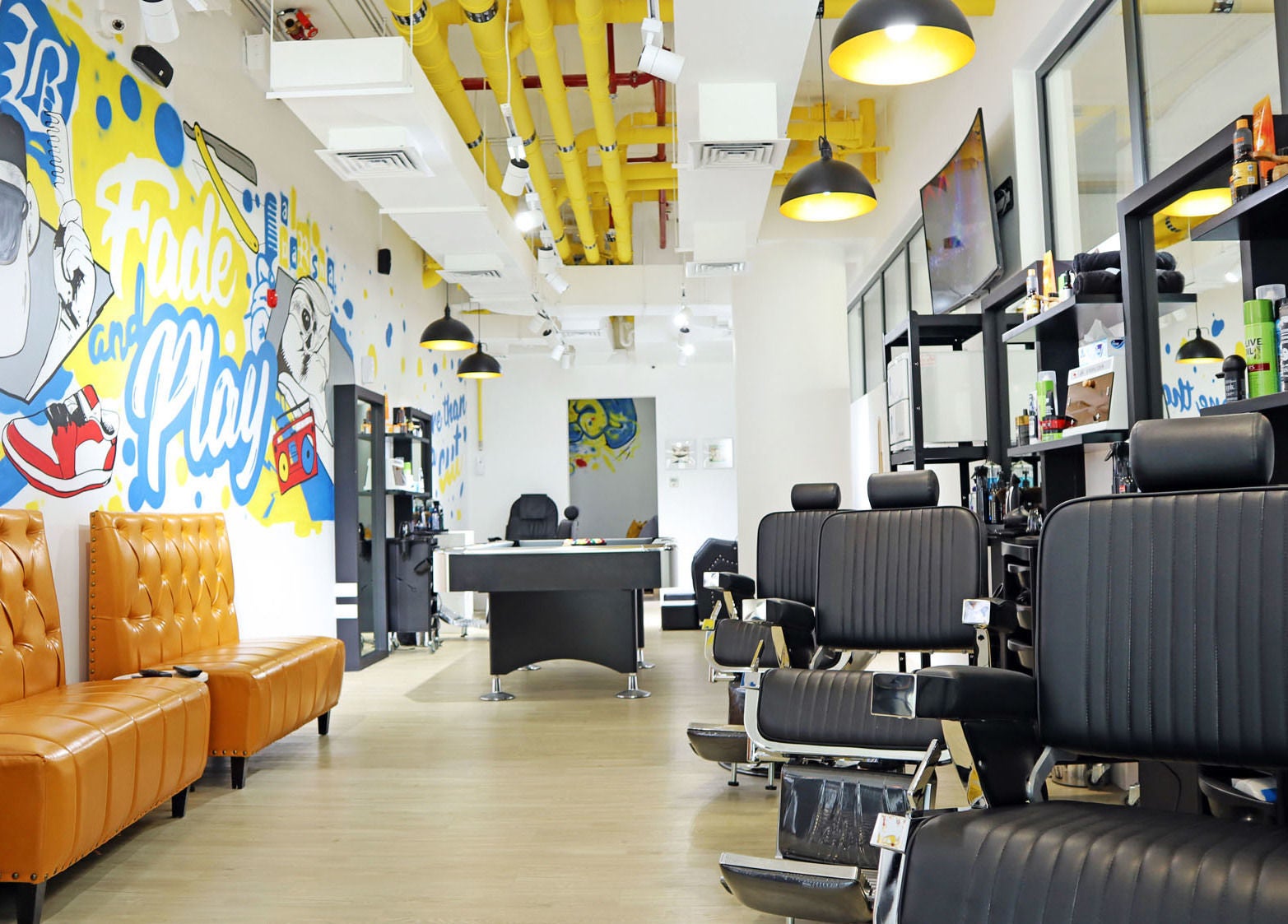 Modern interior of Fade & Play - Al Barsha in Dubai features artistry and stylish seating in a welcoming atmosphere.