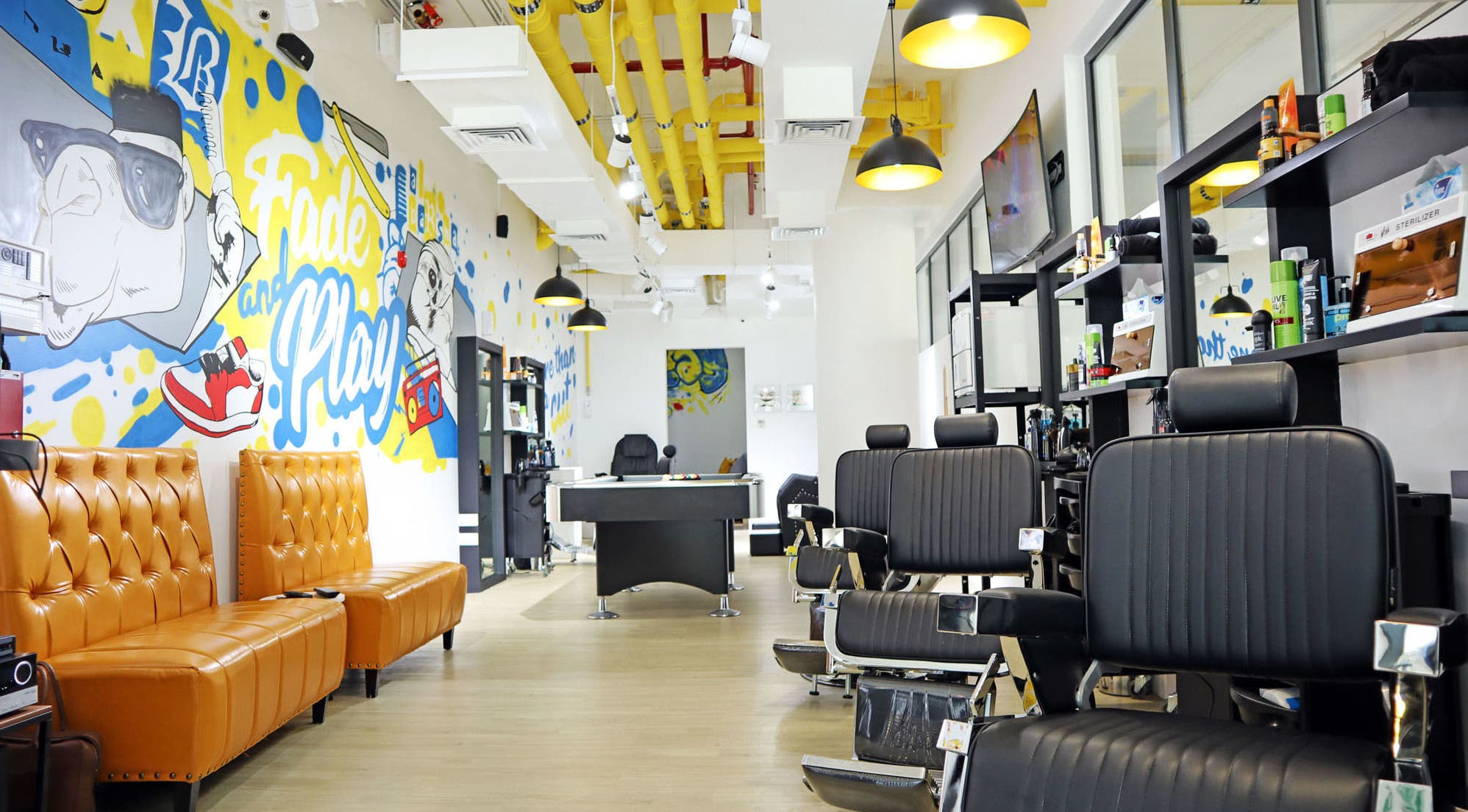 Modern interior of Fade & Play - Al Barsha in Dubai features artistry and stylish seating in a welcoming atmosphere.