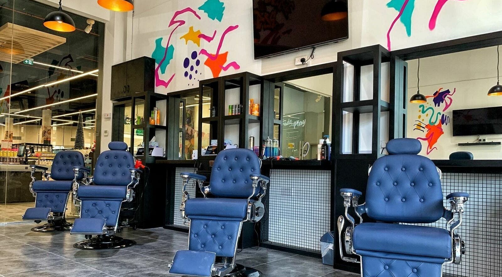 Stylish barber chairs at Fade & Play - Victory Commercial Center | Sports City, Dubai, AE with modern decor.