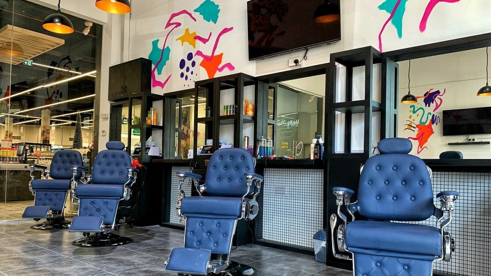 Stylish barber chairs at Fade & Play - Victory Commercial Center | Sports City, Dubai, AE with modern decor.