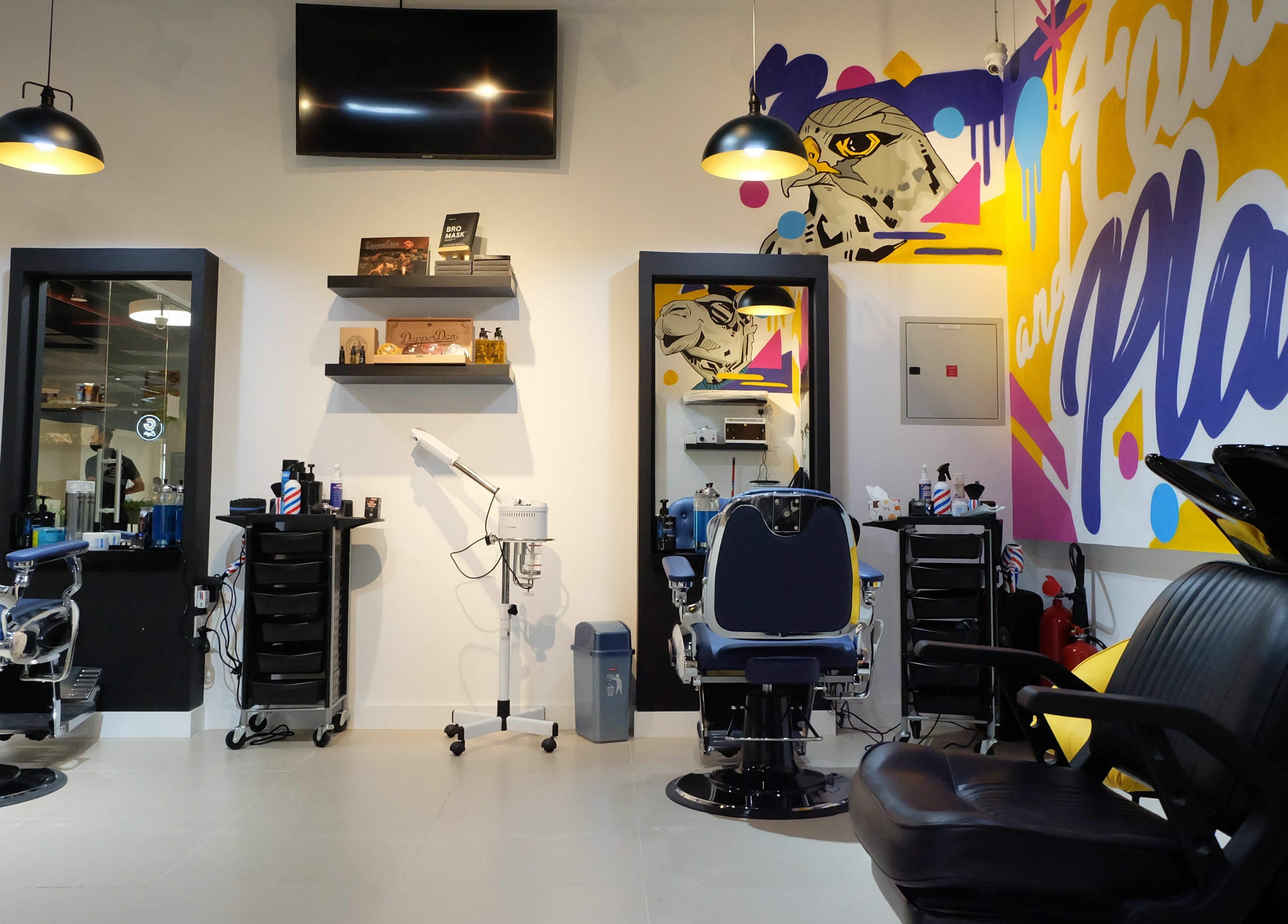Modern barber chairs and artistic decor at Fade & Play - Jumeirah 2 in Dubai, Dubai, AE.