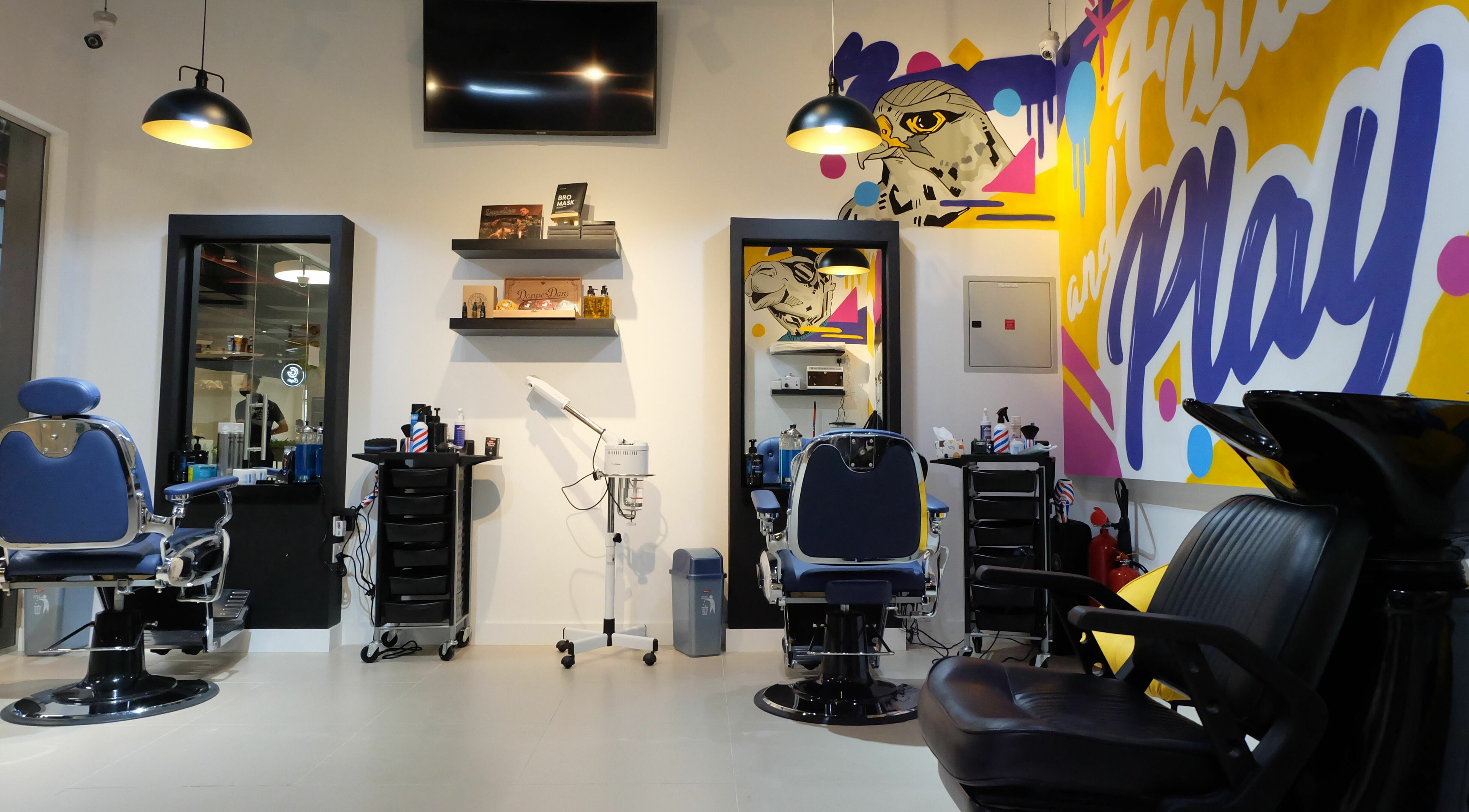 Modern barber chairs and artistic decor at Fade & Play - Jumeirah 2 in Dubai, Dubai, AE.