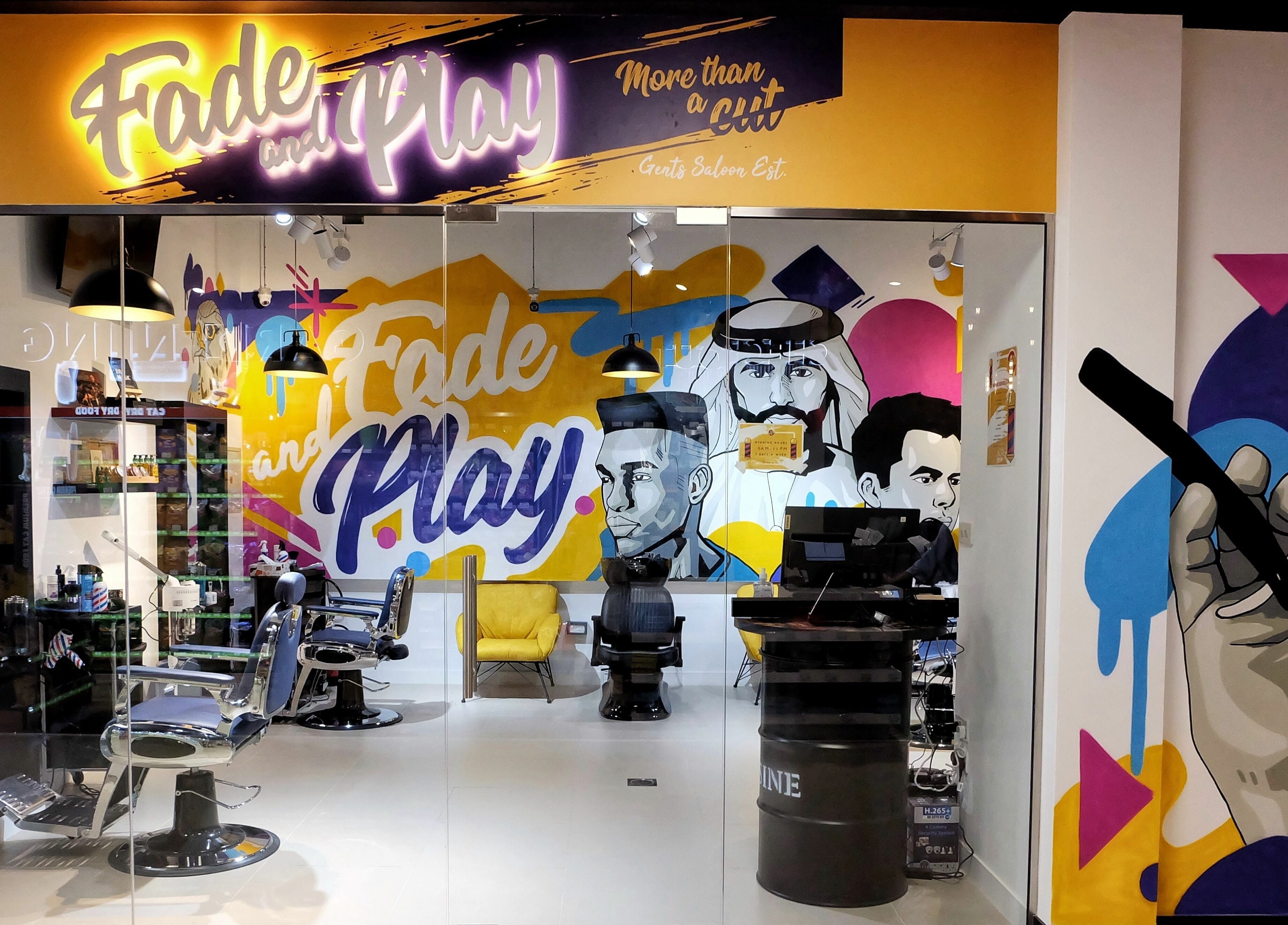 Vibrant interior of Fade & Play - Jumeirah 2, Dubai, Dubai, AE, featuring artistic murals and stylish salon chairs.