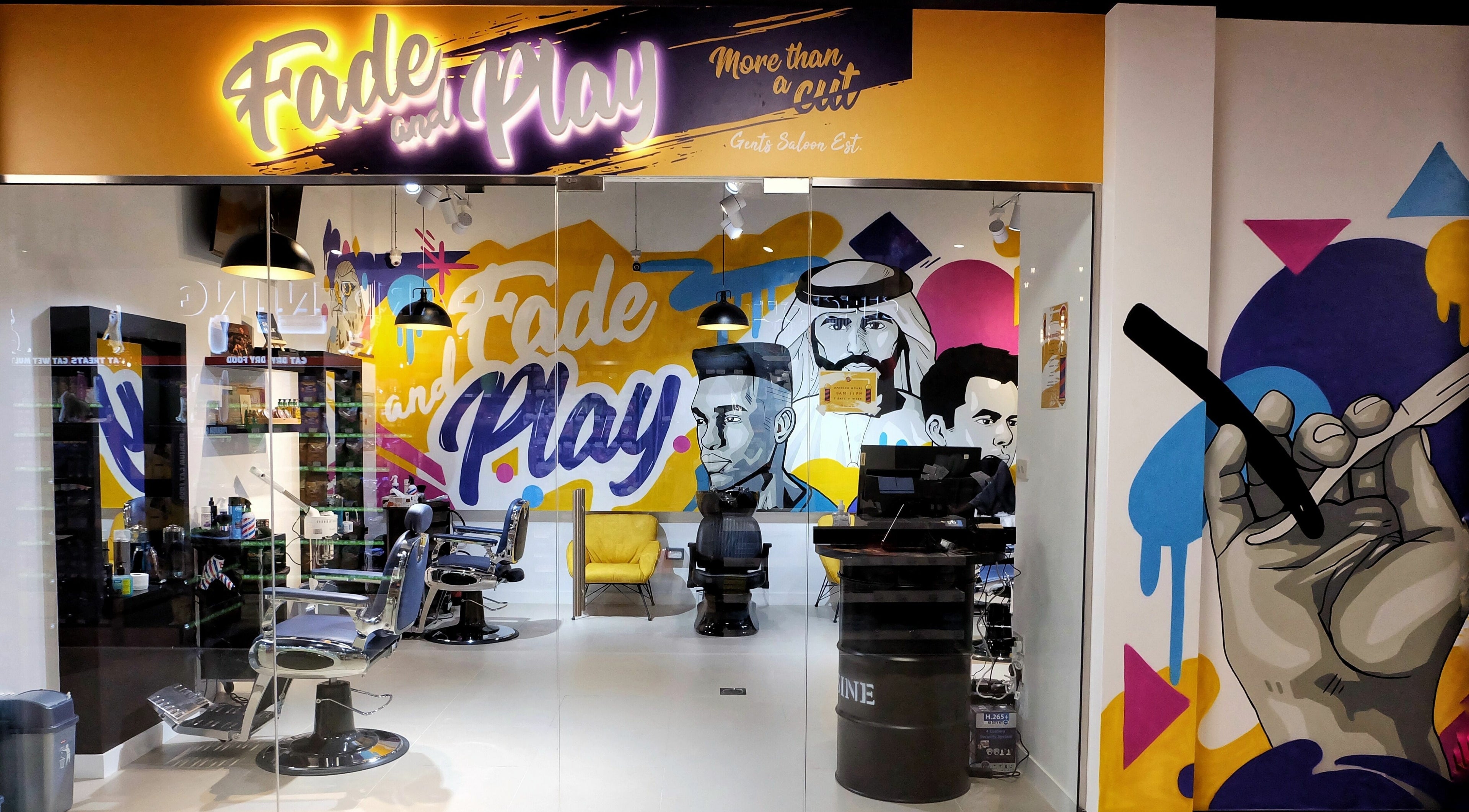 Vibrant interior of Fade & Play - Jumeirah 2, Dubai, Dubai, AE, featuring artistic murals and stylish salon chairs.