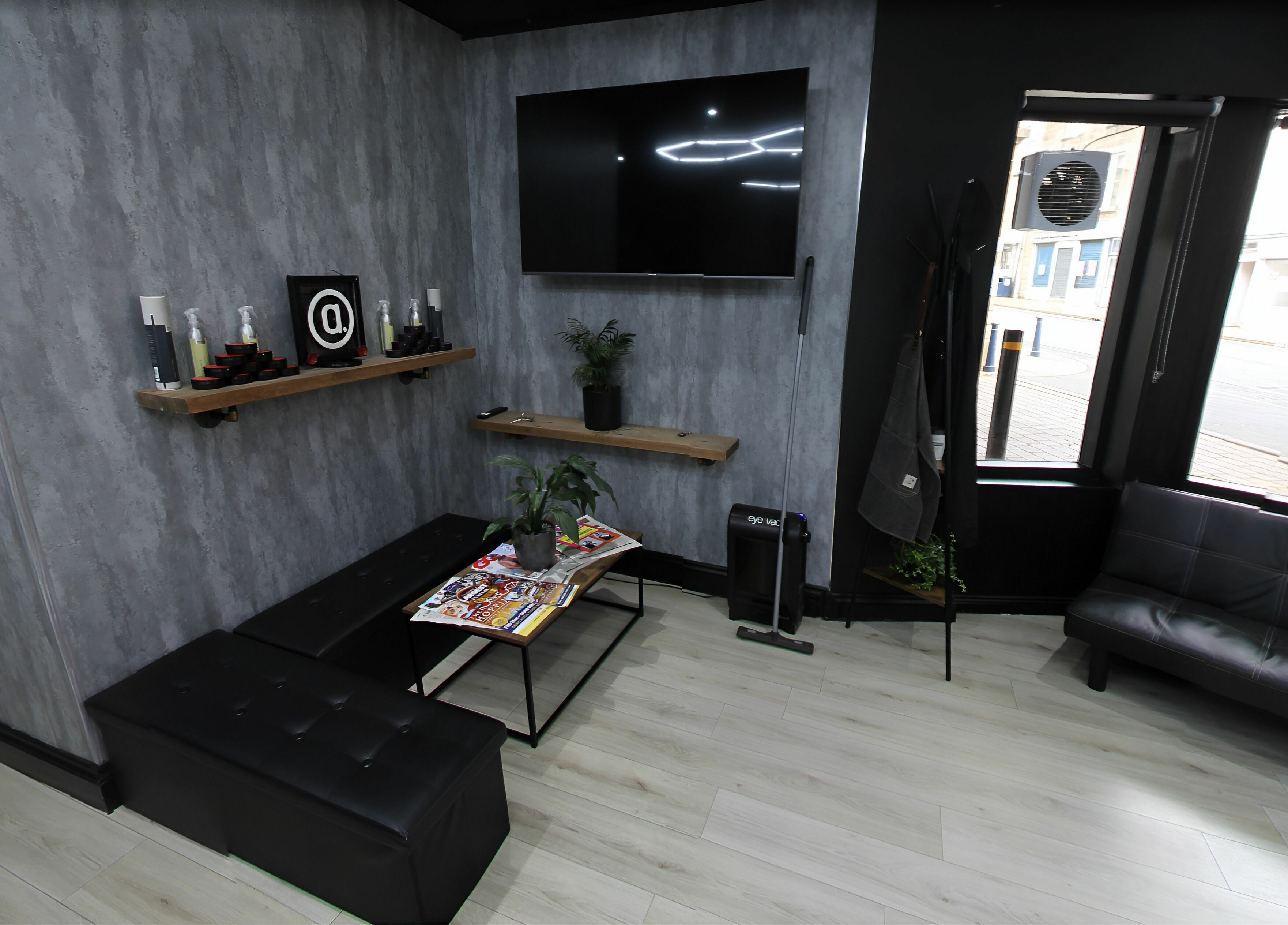 Chic lounge area in Apex Male Grooming, Morpeth, England, GB, featuring sleek seating and decor.